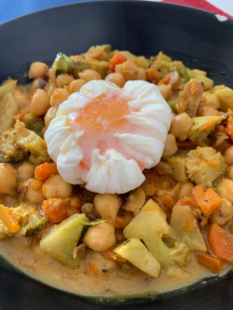 Curry de verduras con garbanzos y huevo poché.