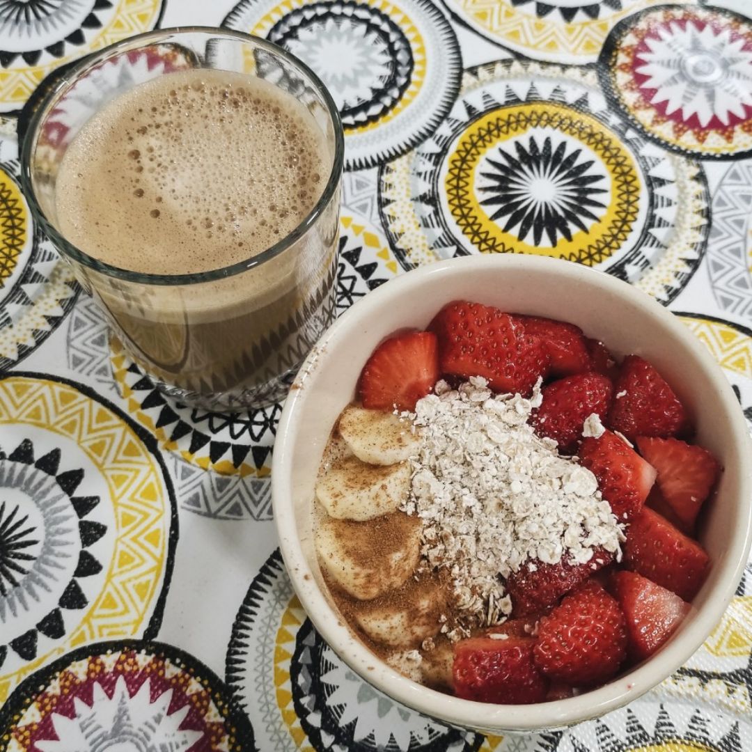 Bol de yogurt con fresas, plátano, avena y canela.