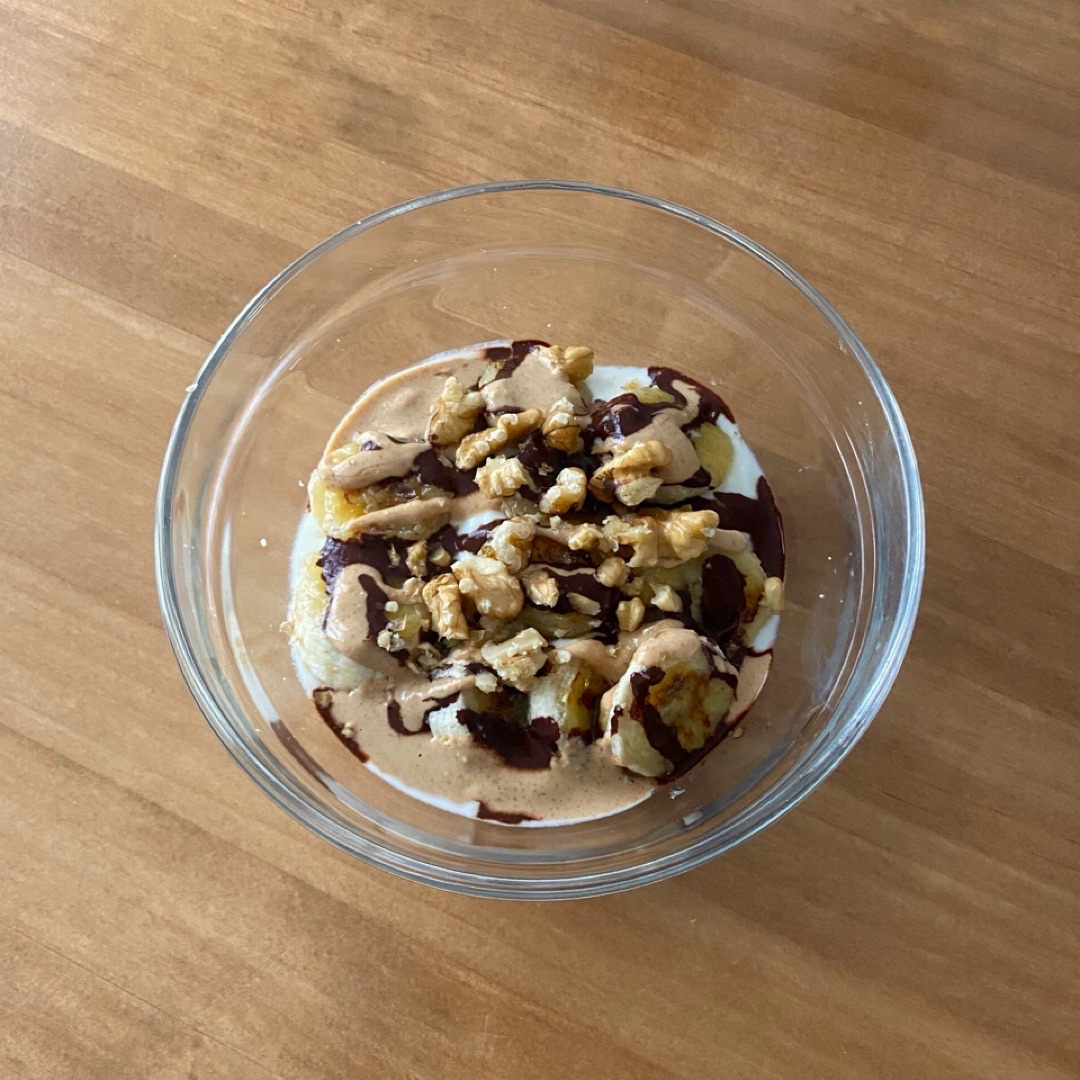 Bol de yogur con plátano, cereales, frutos secos y cacao